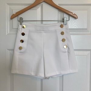 Express white sailor shorts with gold buttons